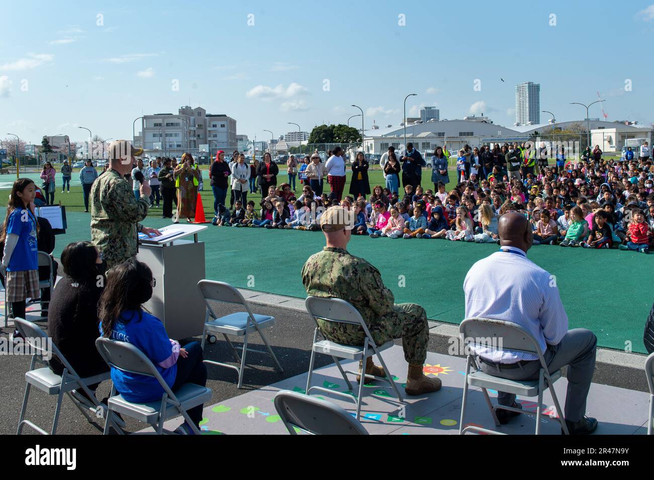 YOKOSUKA, Japan (Apr. 3 2023) –Commander, Fleet Activities Yokosuka’s (CFAY) Capt. Les Sobol, delivers a speech to over 1000 Students of The Sullivans elementary school during the observance of Month of the Military Child. April is designated as the Month of the Military Child, underscoring the important role military children play in the armed forces community. Sponsored by the Department of Defense Military Community and Family Policy, the Month of the Military Child is a time to applaud military families and their children for the daily sacrifices and the challenges they overcome. For 75 ye Stock Photo