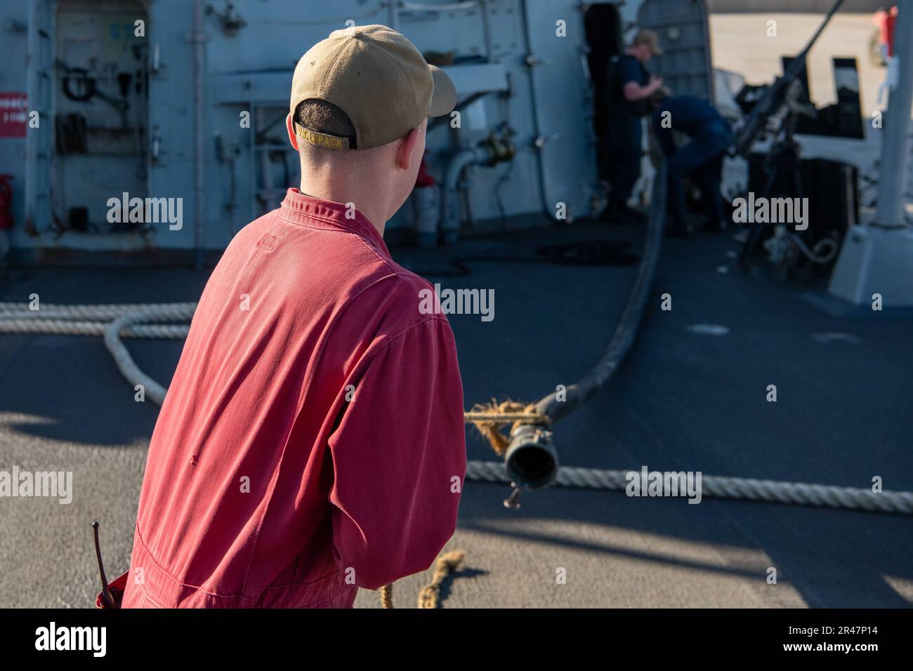 230323-N-MG537-1003 SAL ISLAND, Cabo Verde (March 23, 2023) Hull Technician Second Class Leonard Johnson pulls tubing aboard the Arleigh Burke-class guided missile destroyer USS Bulkeley (DDG 84) in preparation to leave Sal Island, Cabo Verde, March 23, 2023. Bulkeley routinely operates in the U.S. Naval Forces Europe and Africa area of operations, employed by U.S. Sixth Fleet to defend U.S., Allied and Partner interests. Stock Photo