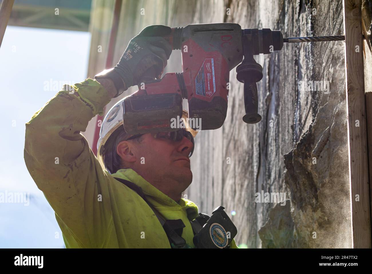 A construction worker drills into the chamber wall for the Charleroi