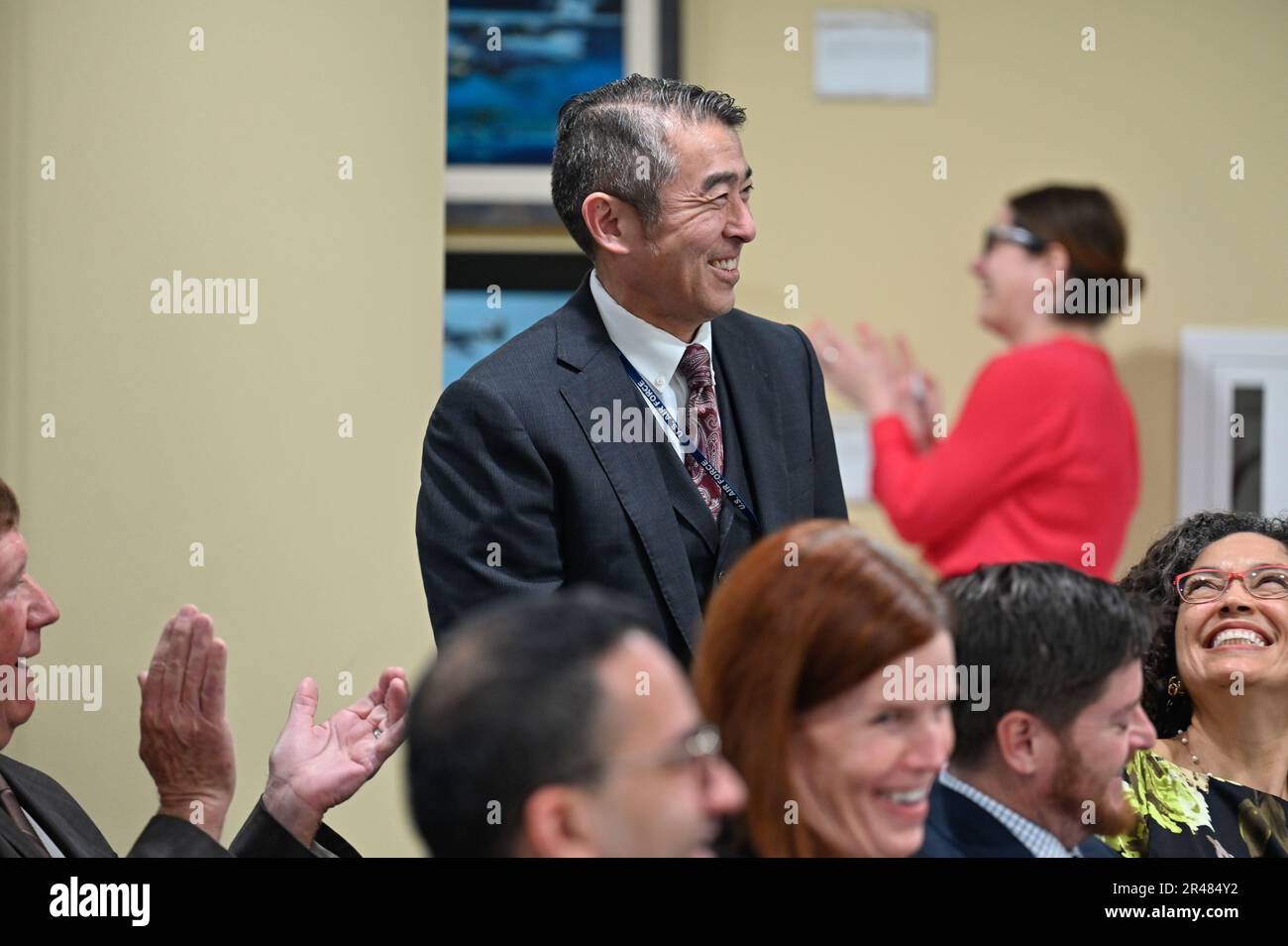 Edwin Oshiba stands to acknowledge Dr. Ravi Chaudhary, assistant