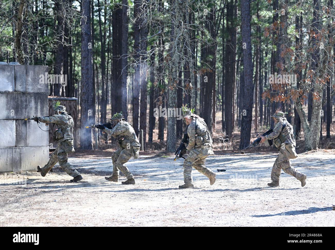 Soldiers assigned to the U.S. Army John F. Kennedy Special Warfare Center and School raid a simulated enemy compound during tactical skills training as part of the Special Forces Qualification Course (SFQC) at Camp Mackall, North Carolina January 9, 2023. Soldiers participated in SFQC training that tested their knowledge of small unit tactics and basic urban operations to ensure they possess the combat skills required to successfully operate on a Special Forces Operational Detatchment Alpha. Stock Photo