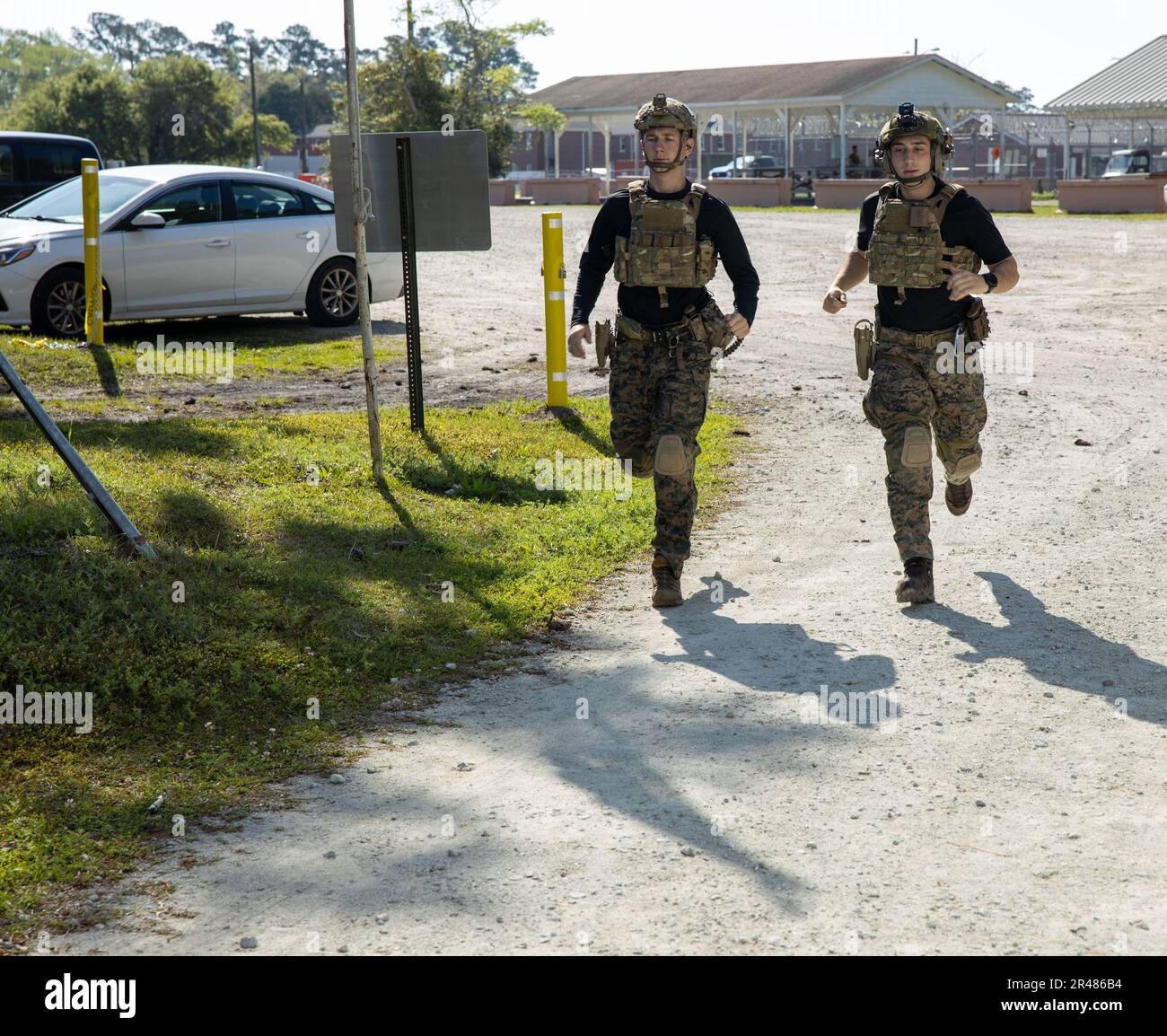 U.S Marine Corps urban sniper instructor (left) and Staff Sgt. Santore Francis (right) urban sniper instructors with Expeditionary Operations Training Group (EOTG), II Marine Expeditionary Force, run during the Sniper Sustainment Course (SSC) aboard Marine Corps Base Camp Lejeune, North Carolina, April 5, 2023. The SSC provides the opportunity for the Special Tactics Branch of EOTG to restructure the Urban Sniper Course to better suit the needs of the Recon Snipers that will remain in service for the Marine Corps and to conduct advanced marksmanship training to validate the standards for futur Stock Photo