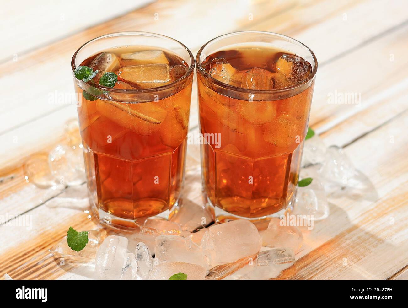Two Glass Sweet Cold Ice Tea or Es Teh Manis on Wooden Table. Fresh Summer Drink Concept Stock Photo