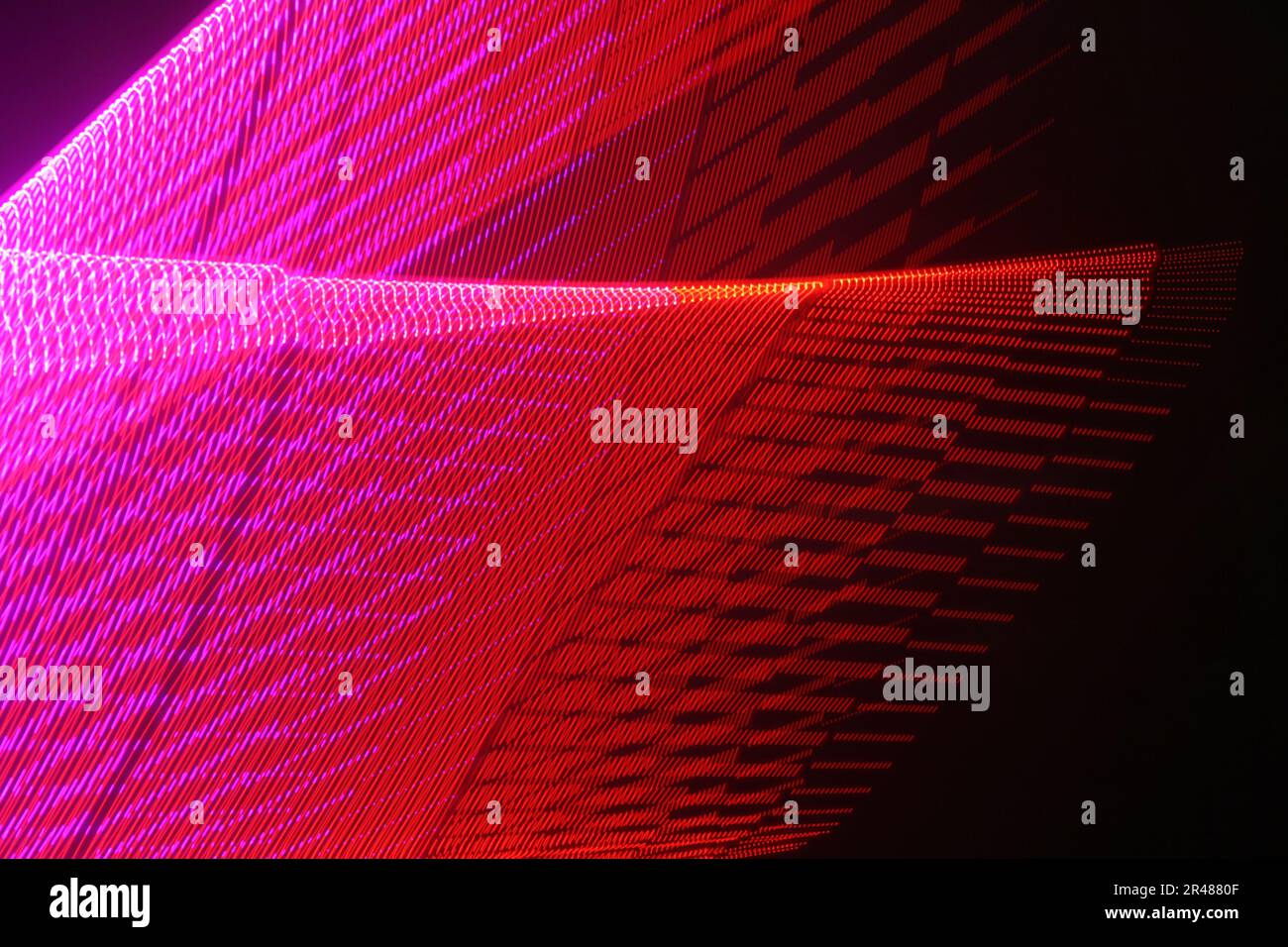 A large display featuring a pattern of red lights radiating outward along distinct lines Stock Photo