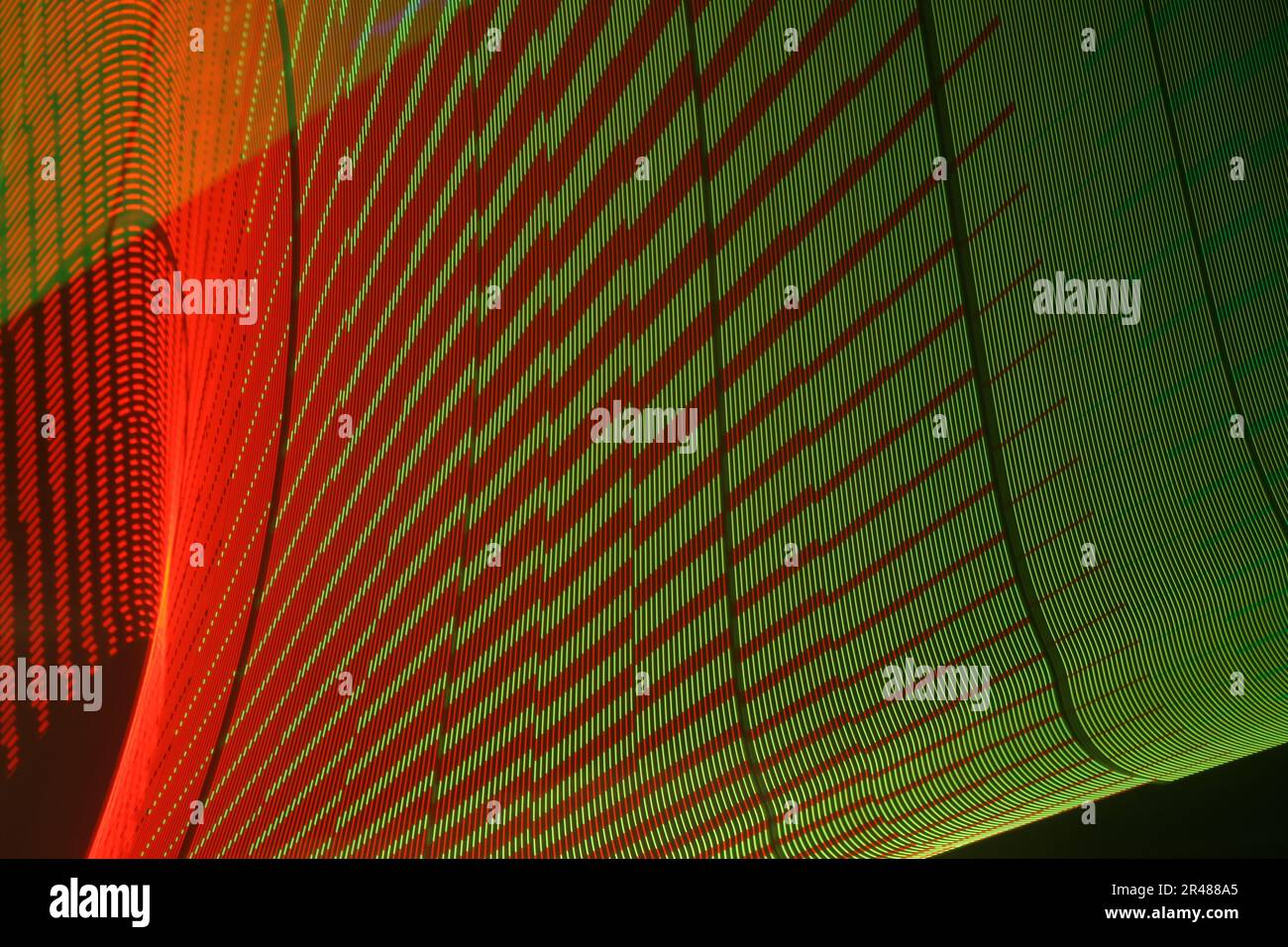 A large display featuring a pattern of green and red lights radiating outward along distinct lines Stock Photo