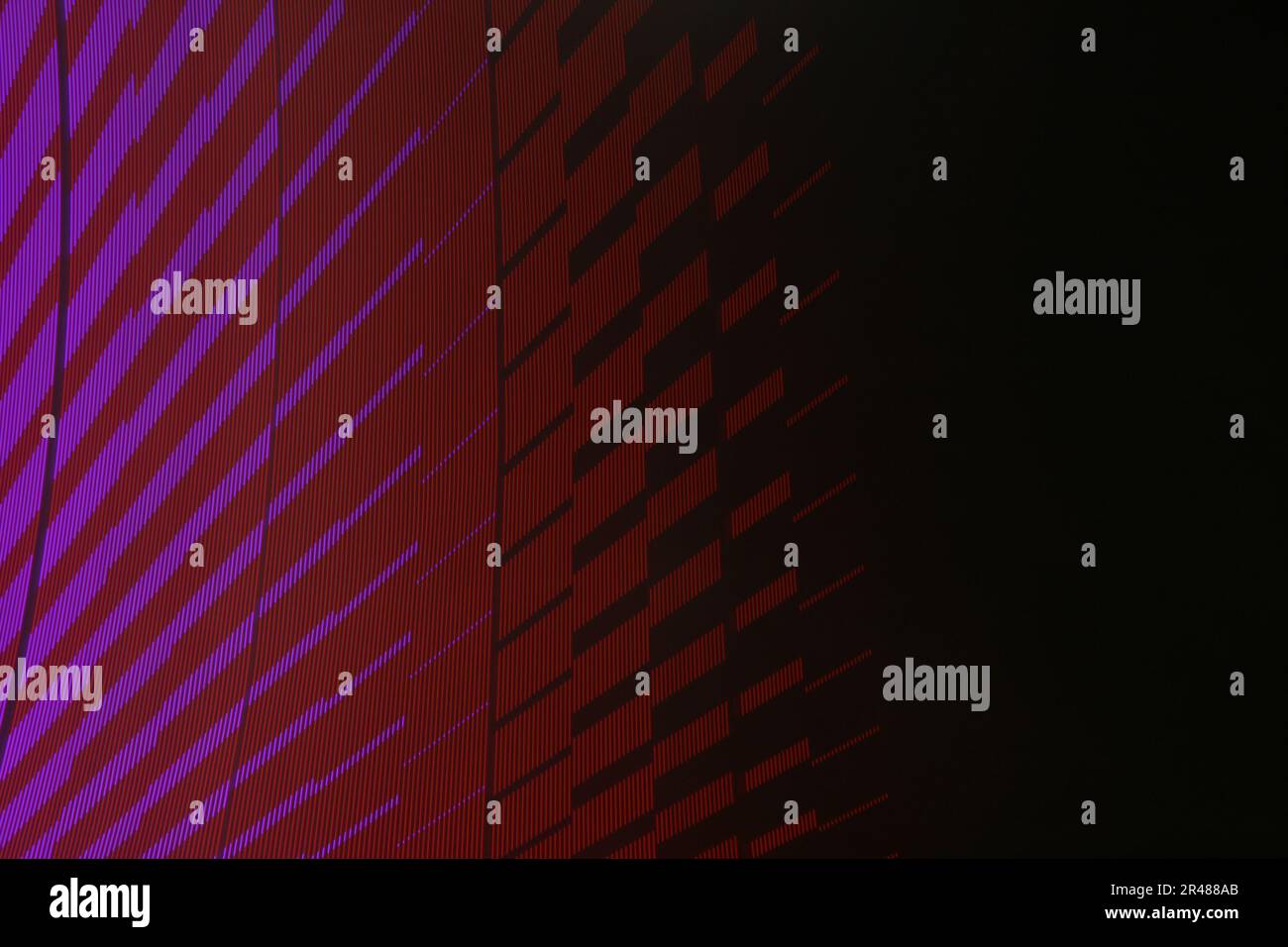 A large display featuring a pattern of purple and red lights radiating outward along distinct lines Stock Photo
