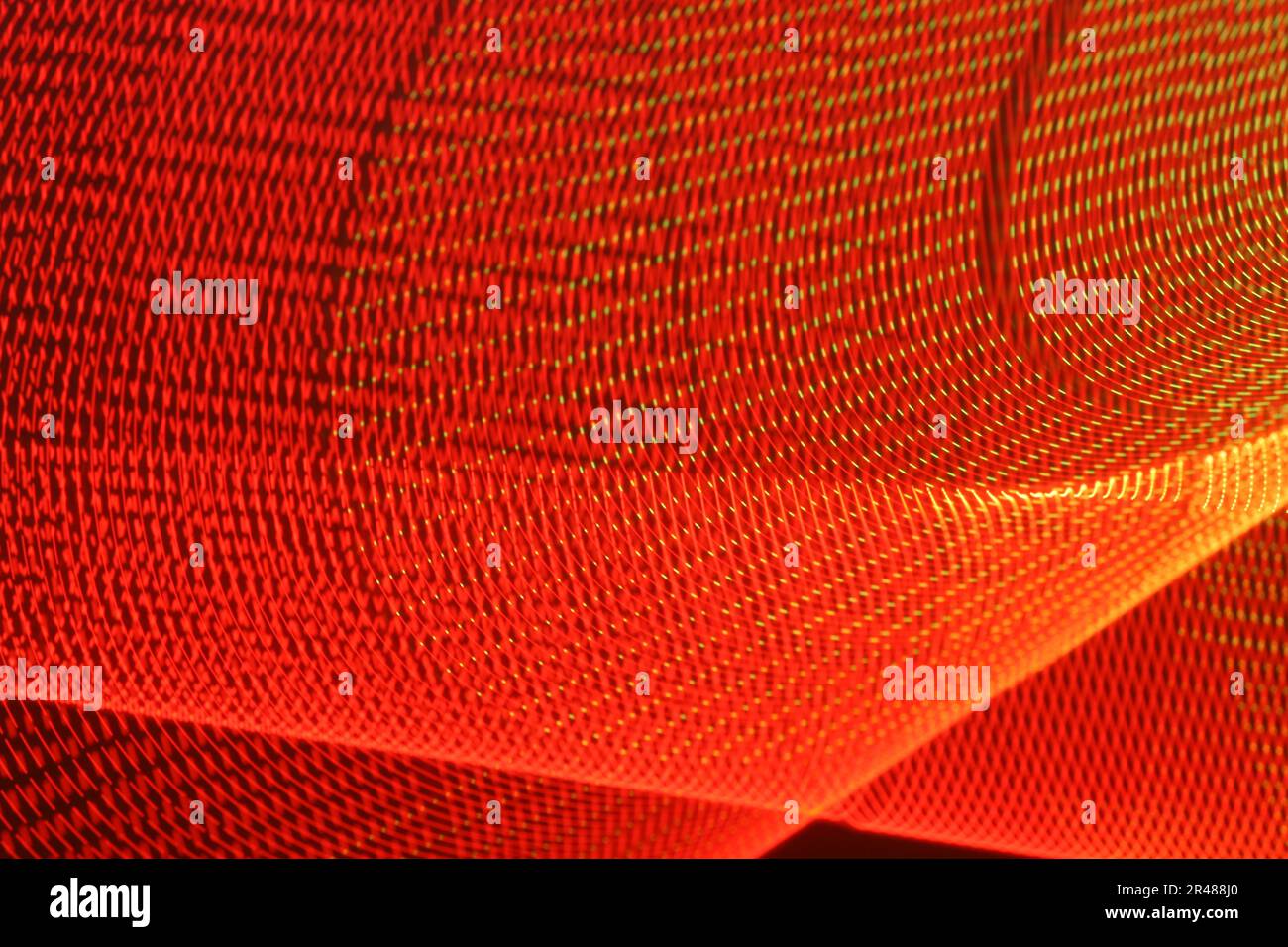 A large display featuring a pattern of red lights radiating outward along distinct lines Stock Photo