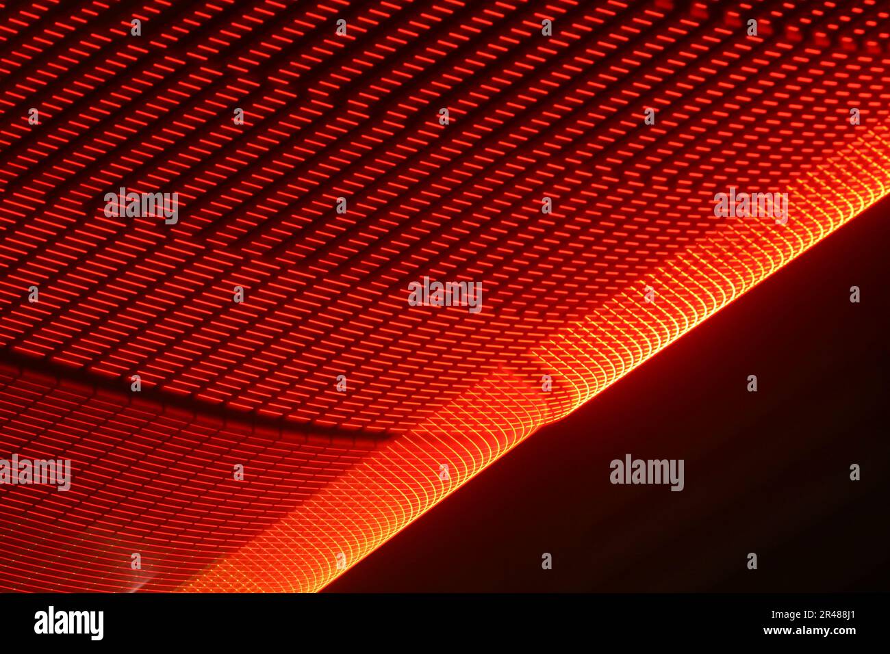 A large display featuring a pattern of red lights radiating outward along distinct lines Stock Photo