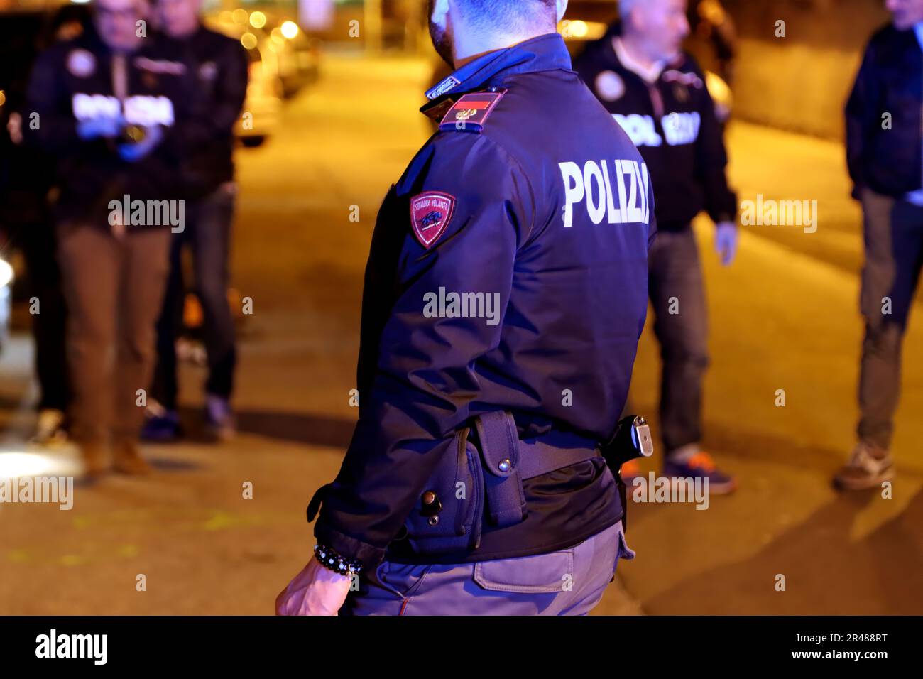 Italian police officers investigating a nighttime murder scene. Italian police at night Stock Photo