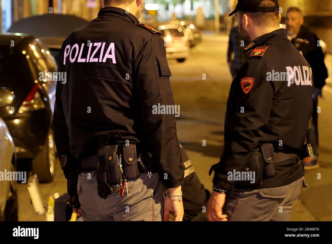 Italian police officers investigating a nighttime murder scene. Italian police at night Stock Photo