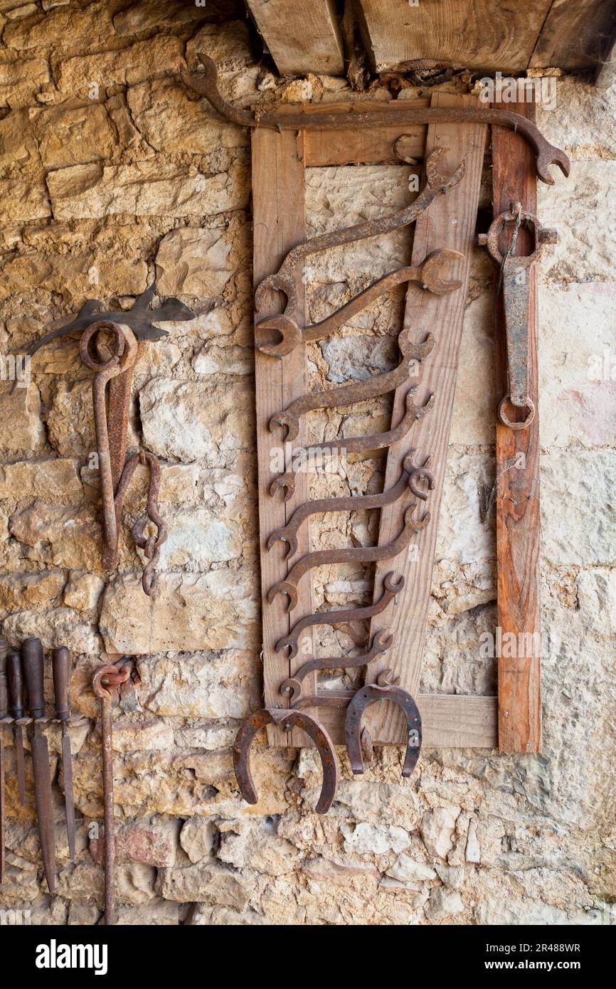 Old set of tools (files, wrenches…) for a blacksmith. Stock Photo