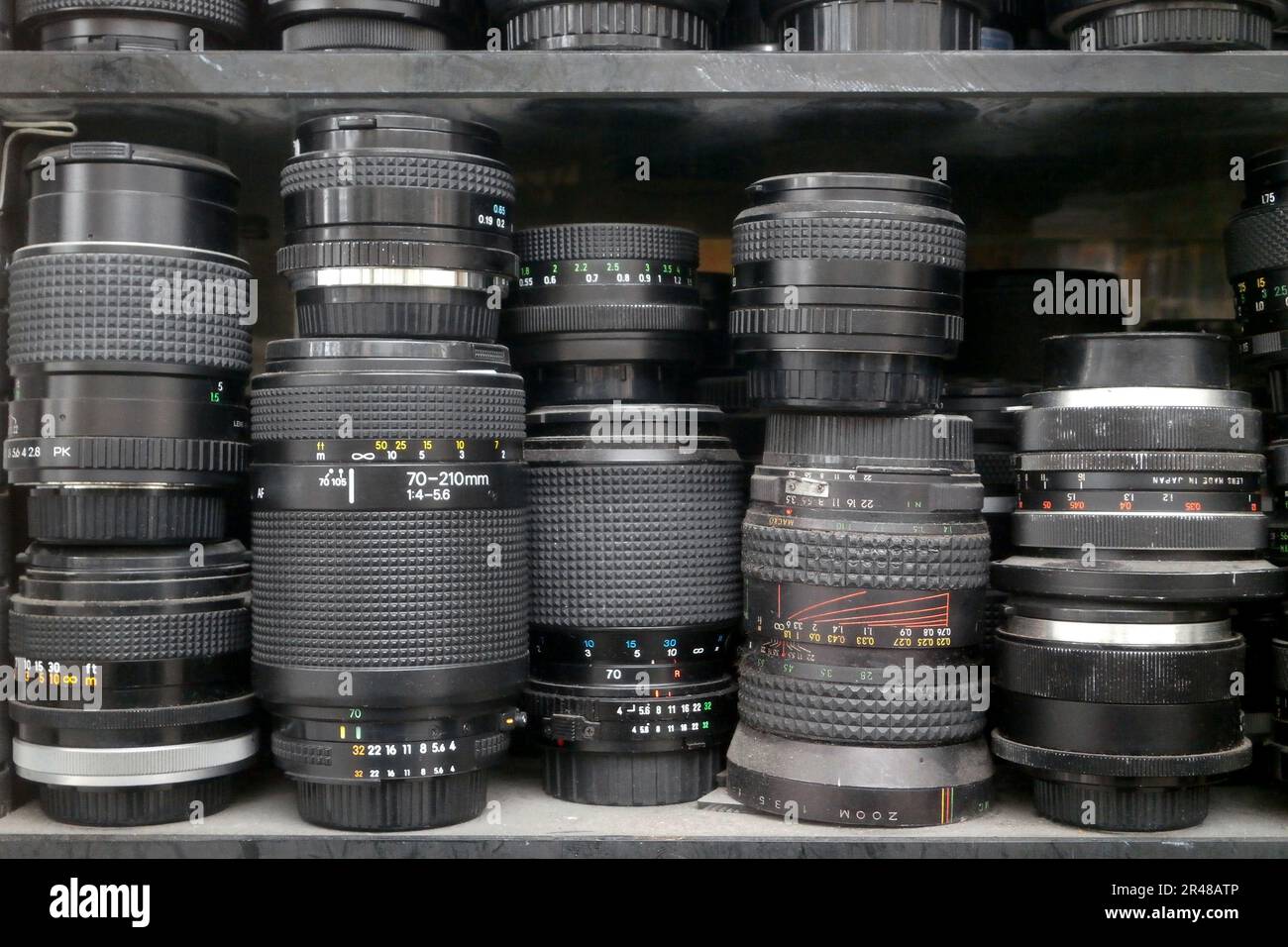 Stack of camera lenses and doubleurs on a shelf Stock Photo Alamy