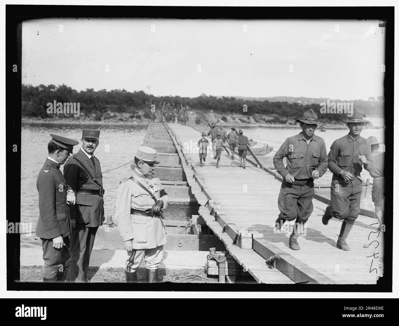 US Army Eng. Col. and French Officers at pontoon bridge built by US ...