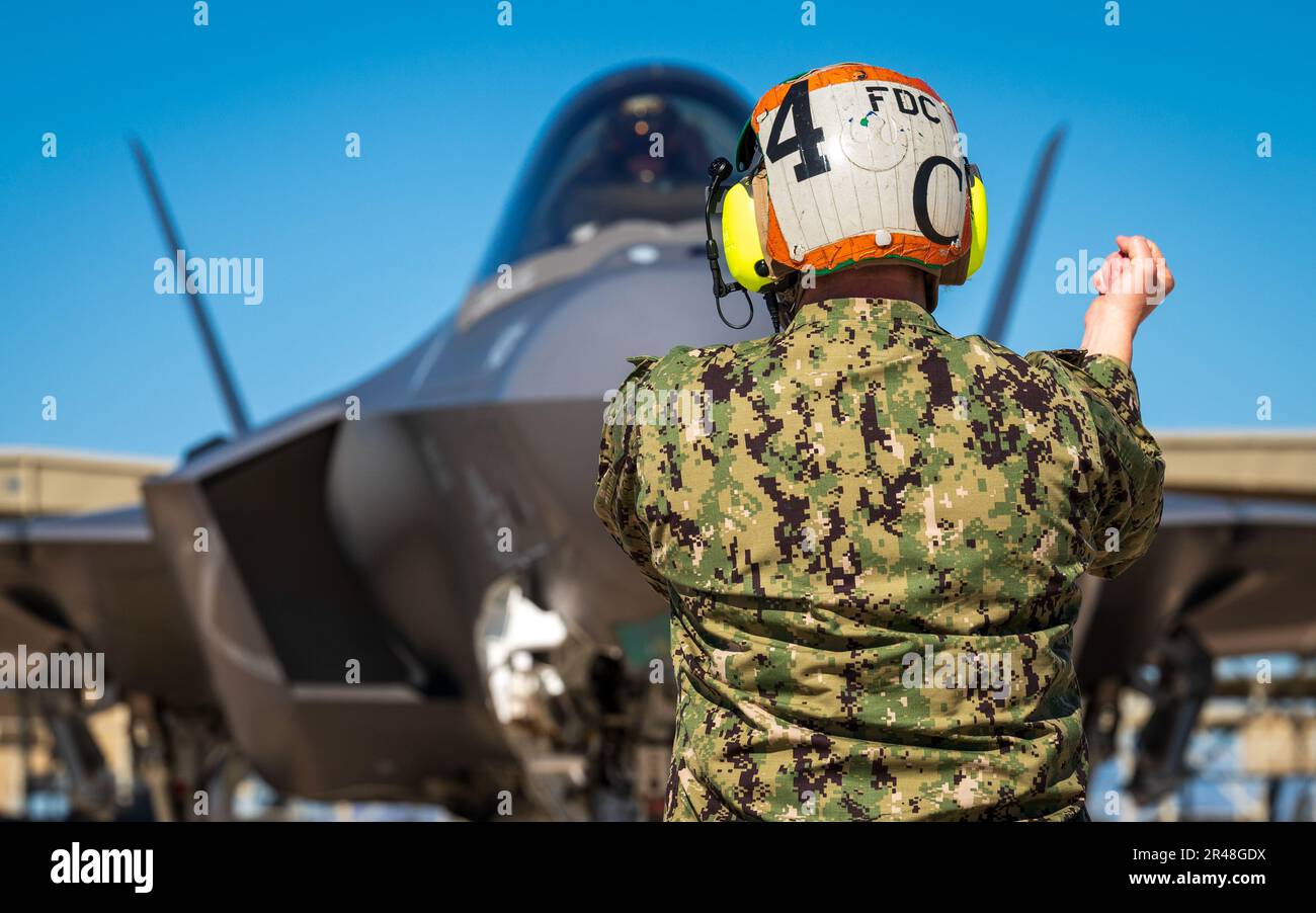 U.S. Navy ADC Tabitha Bledsoe communicates with the pilot of an F35C