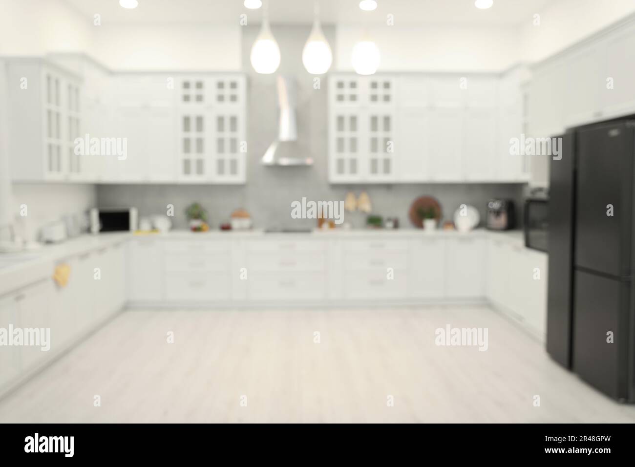 Stylish spacious kitchen with furniture, blurred view. Interior design ...