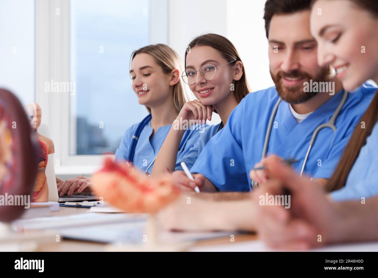 Medical students in uniforms studying at university Stock Photo