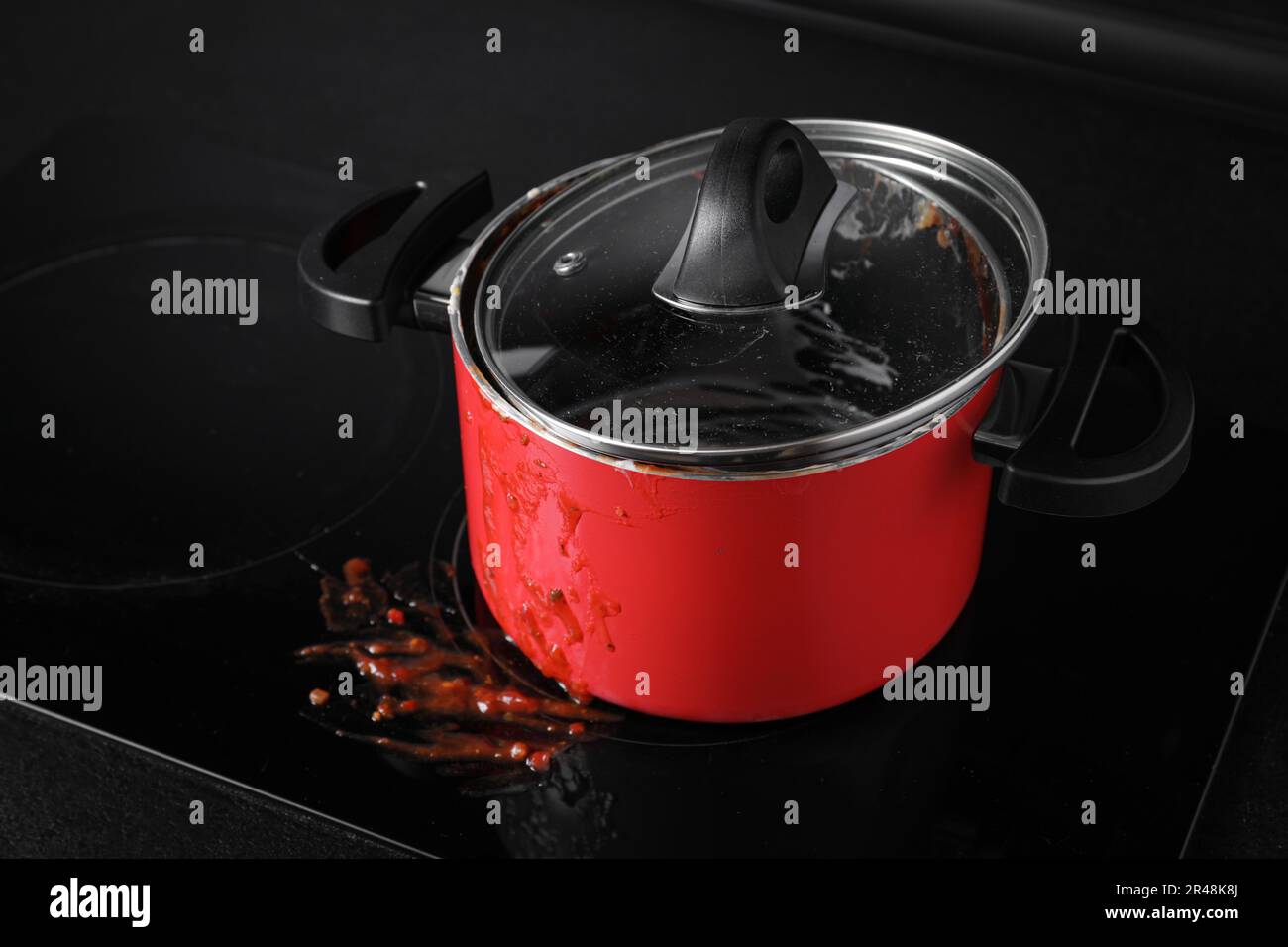 Dirty pot with lid on cooktop in kitchen Stock Photo - Alamy