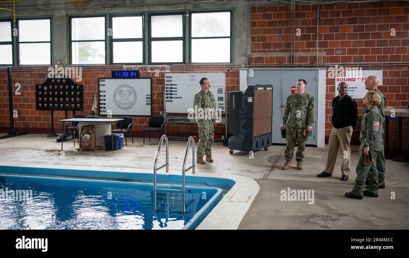Captain Kimberly Toone, commanding officer Navy Medicine Operational Training Command (NMOTC), and Command Master Chief C.J. Eison, NMOTC, are given a tour of the Aviation Rescue Swimmer Pool from CDR Heath Clifford, officer in charge Aviation Survival Training Center Jacksonville (ASTC JAX)(left), Mar. 09, 2023. ASTC JAX is one of eight ASTC training facilities that are encompassed by the Navl Aviation Survival Training Institue (NSTI). NSTI, a detachment of NMOTC, specializes in training the pilots, aircrew, and service members who support other specialized communities in survival skills and Stock Photo