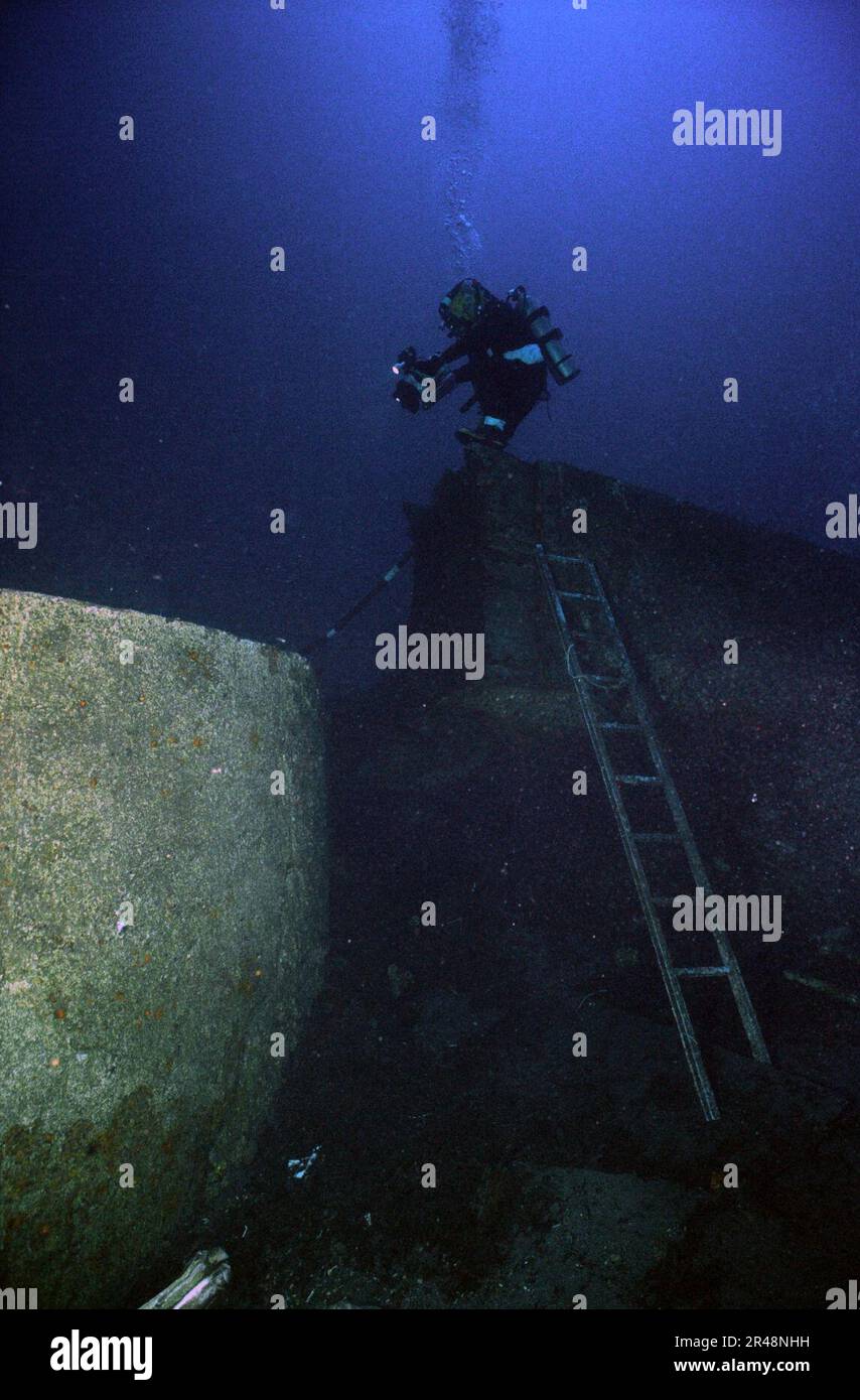 US Navy Photographer's Mate 1st Class shoots video of the inside of USS