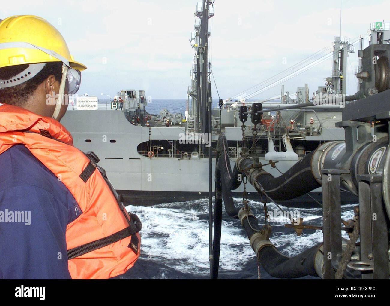 Unrep Estream US Navy Sailor mans his station during an unrep Stock Photo - Alamy