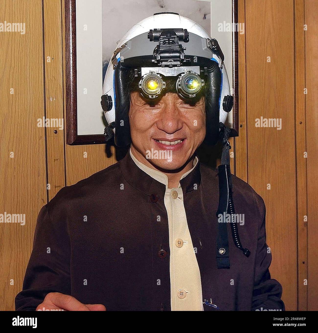US Navy Jackie Chan tries on a fighter pilot's helmet with night vision