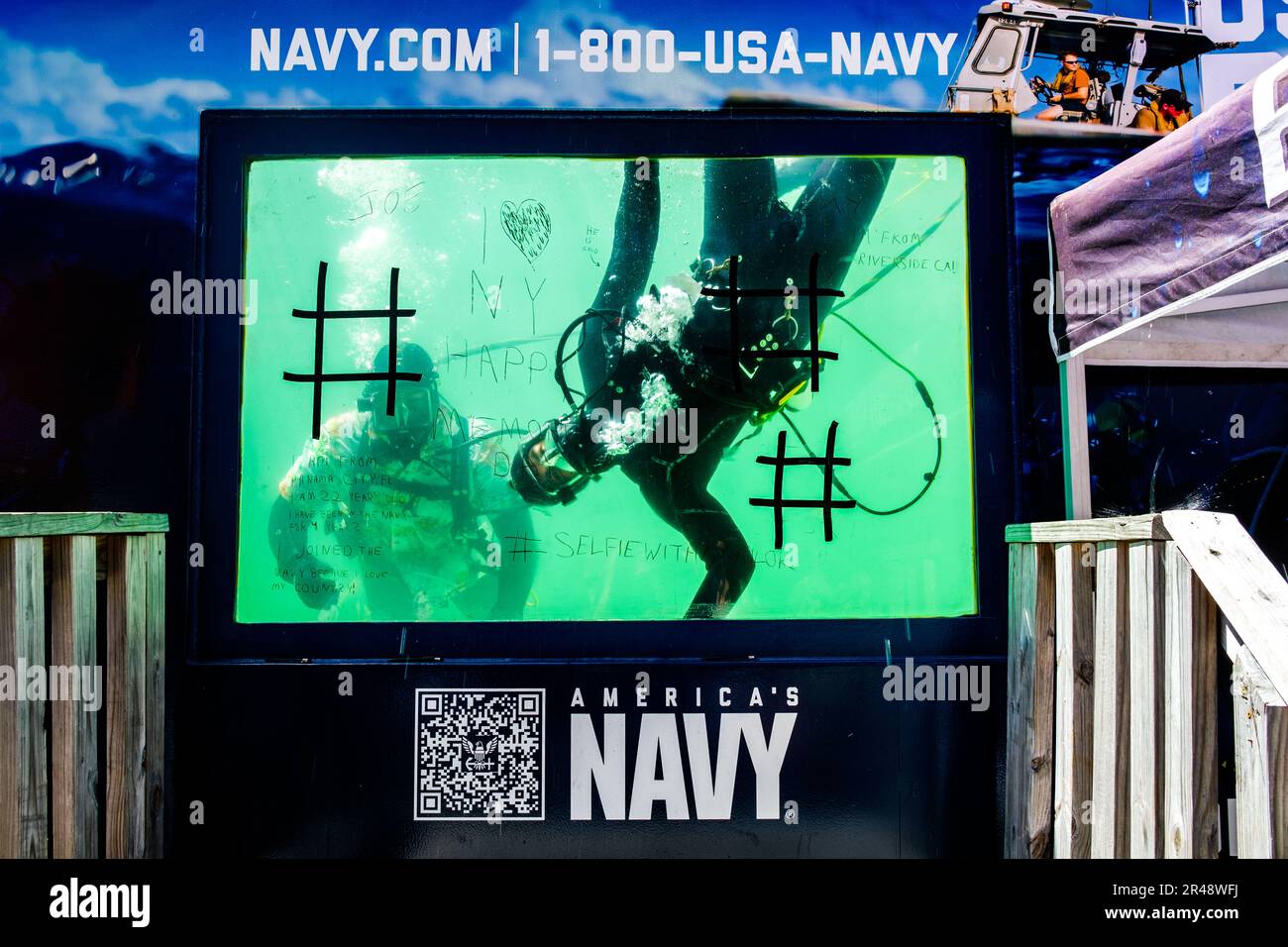 New York, New York, USA. 26th May, 2023. US Navy Divers greet civilians in dive tank in Times Square during Fleet Week NYC 2023. The Parade of Ships kicksed off on the Hudson River as naval vessels from the US, UK, Canada and Italy along with thousands of sailors, coast guard and marines. The week long annual celebration of events and performances with men and women in white all over city streets is a welcome sight for New Yorkers. (Credit Image: © Milo Hess/ZUMA Press Wire) EDITORIAL USAGE ONLY! Not for Commercial USAGE! Stock Photo