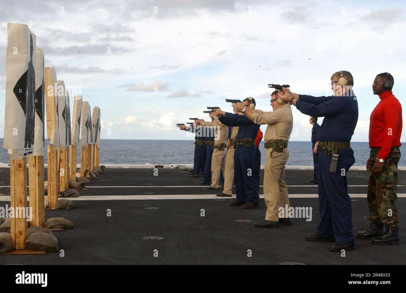 US Navy Gunner's Mates train and supervise handgun qualifications on