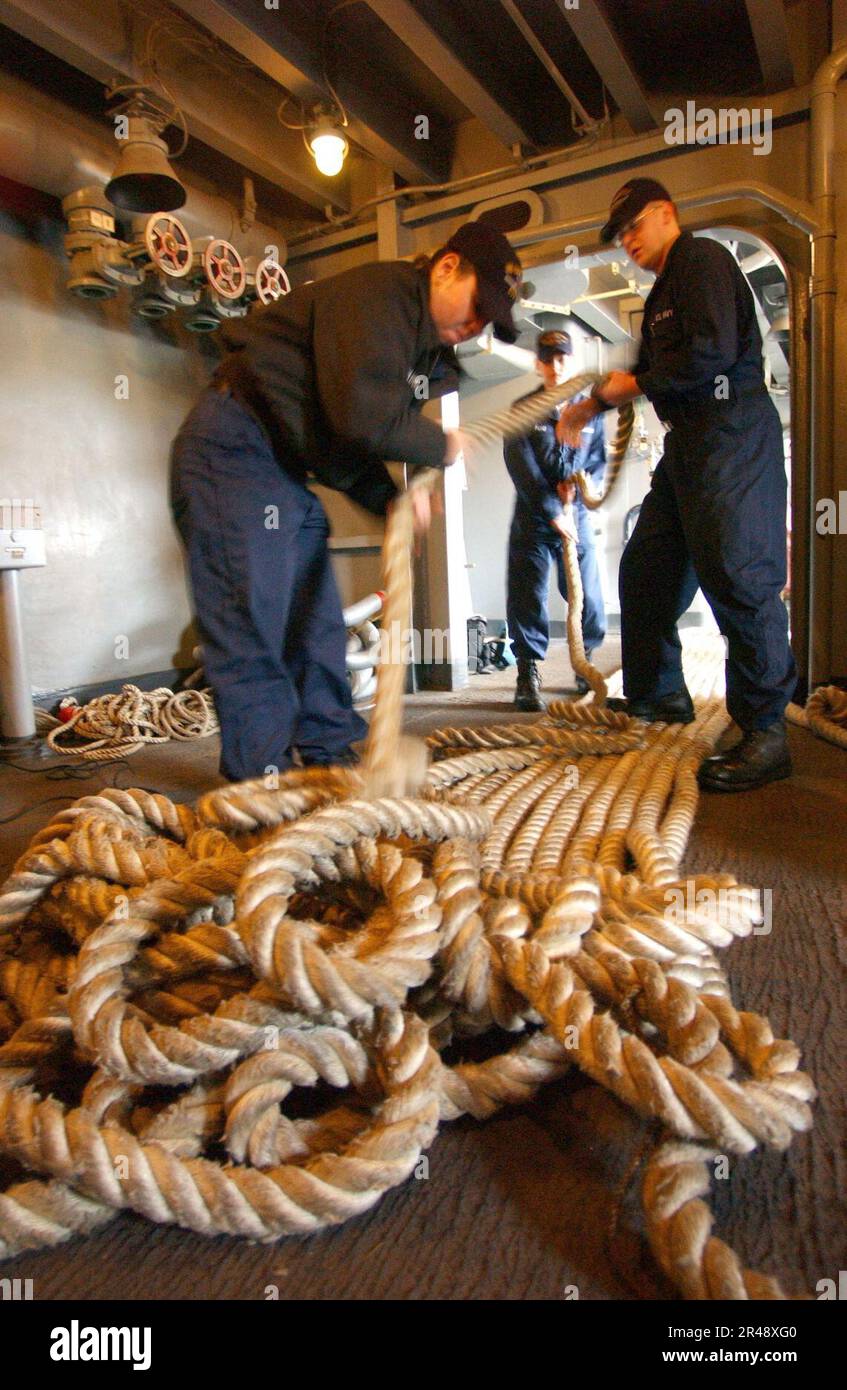 US Navy Sailors assigned to the ship's deck department, flakeout the