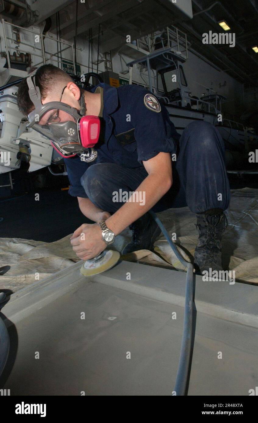 US Navy sanding down a door for repainting Stock Photo Alamy