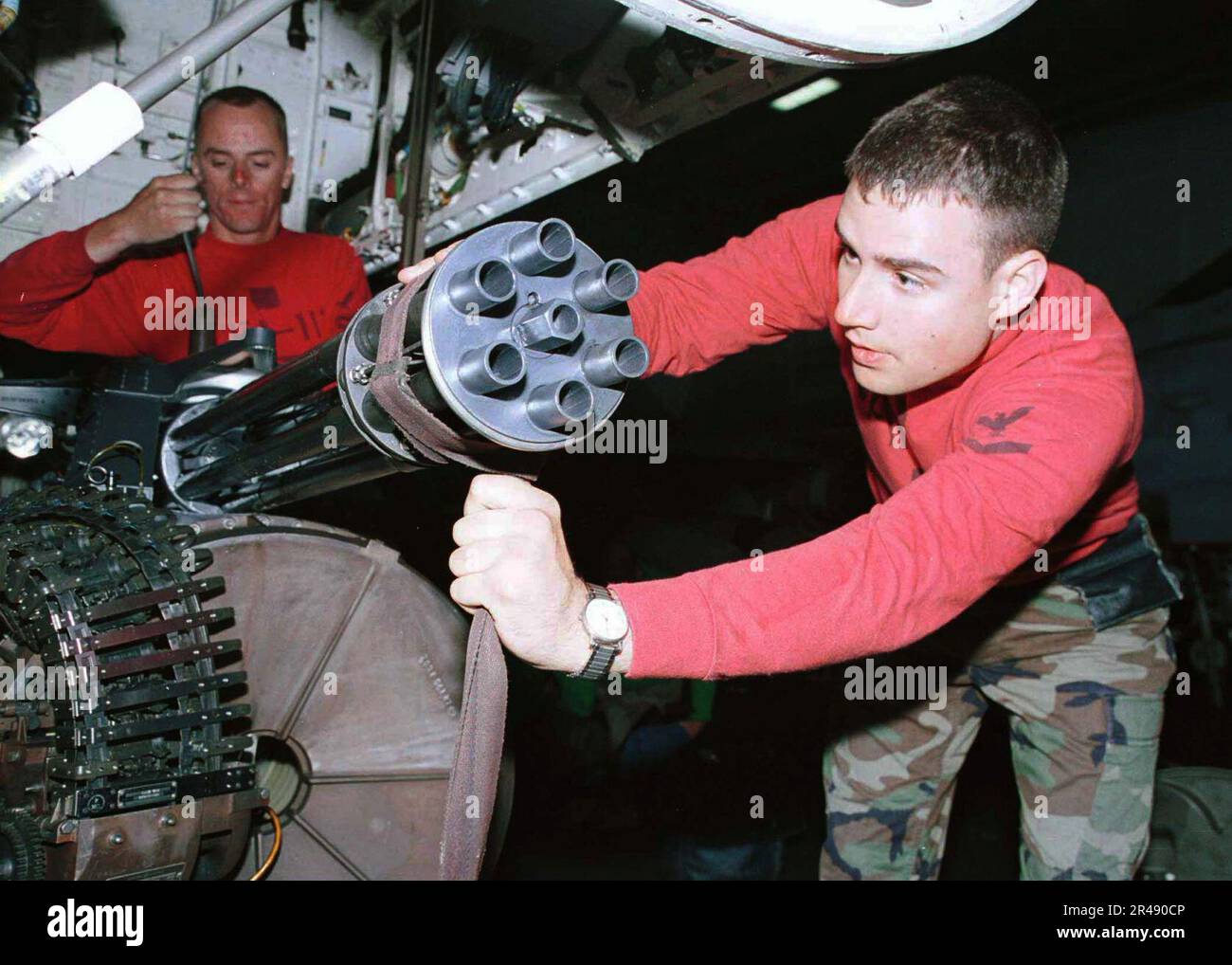 US Navy Aviation Ordnanceman perform maintenance on the M61A1 Vulcan 20mm cannon Stock Photo