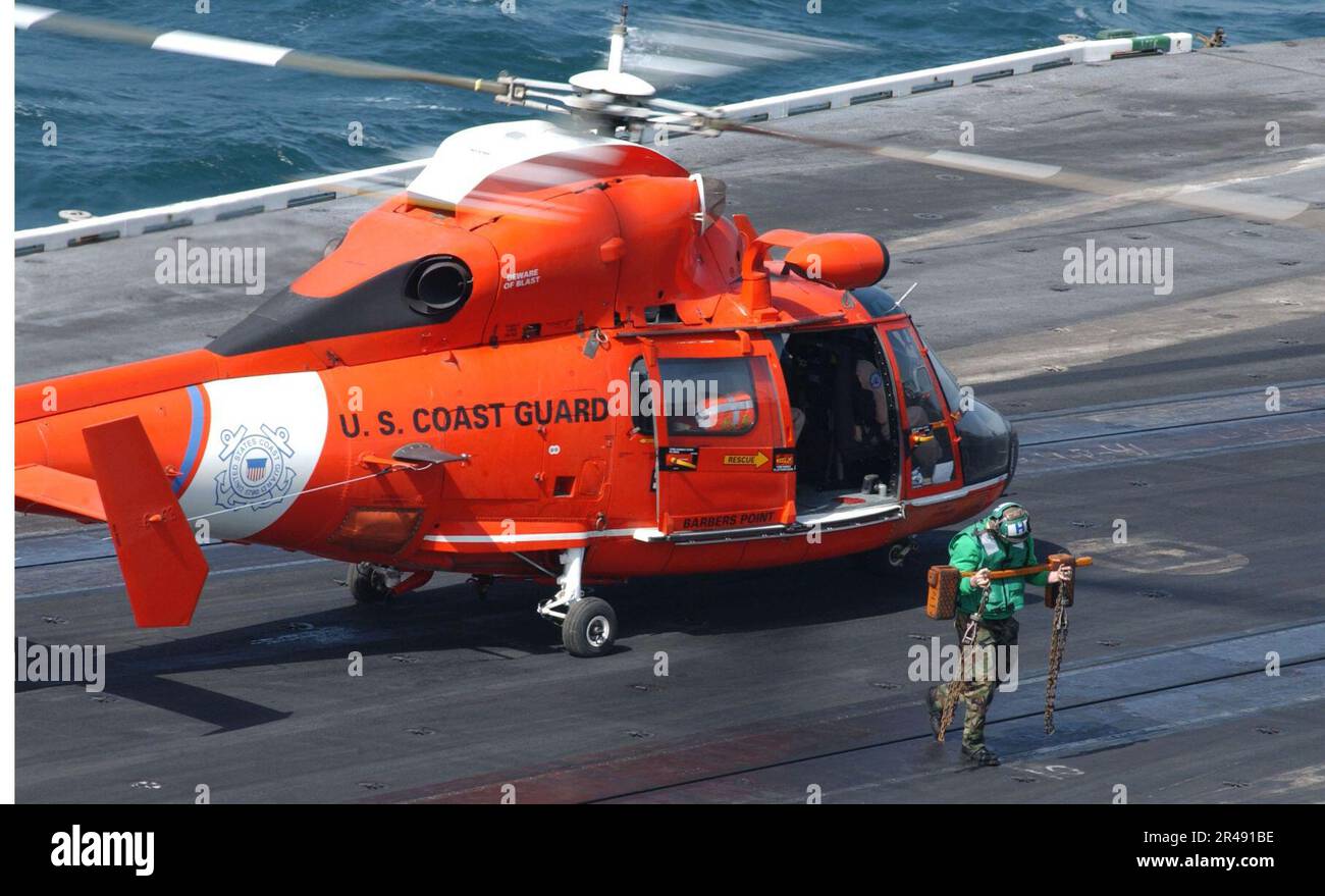 US Navy Flight deck personnel aboard USS Constellation (CV 64) remove wheel chocks and tiedown