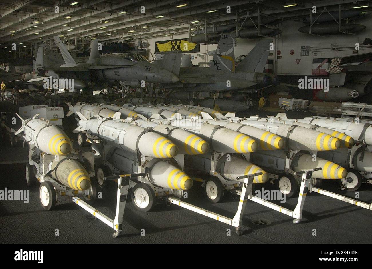 US Navy Bunker Buster bombs are staged in the hangar bay aboard USS