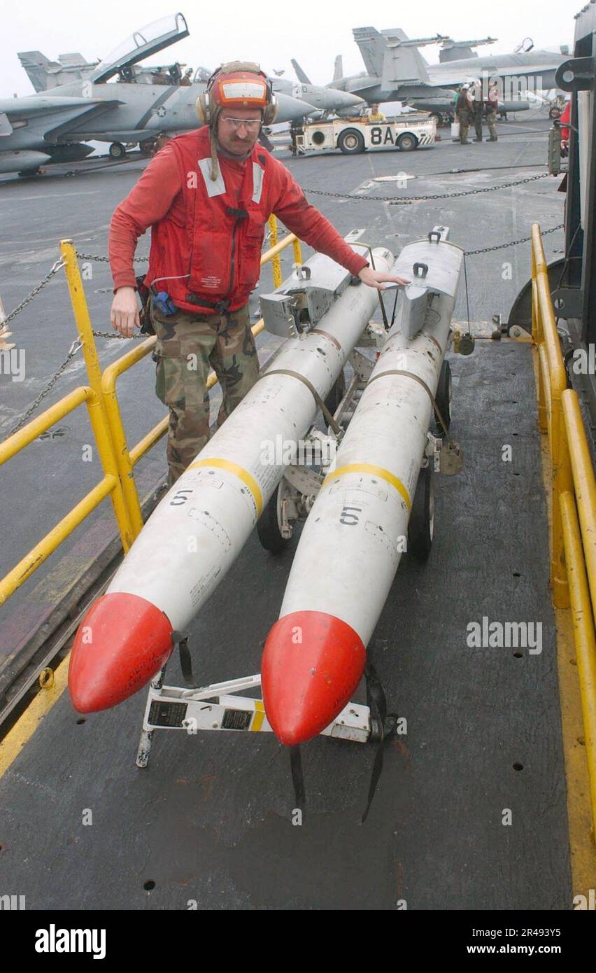 US Navy Aviation Ordnanceman 1st Class inspects missiles before they ...