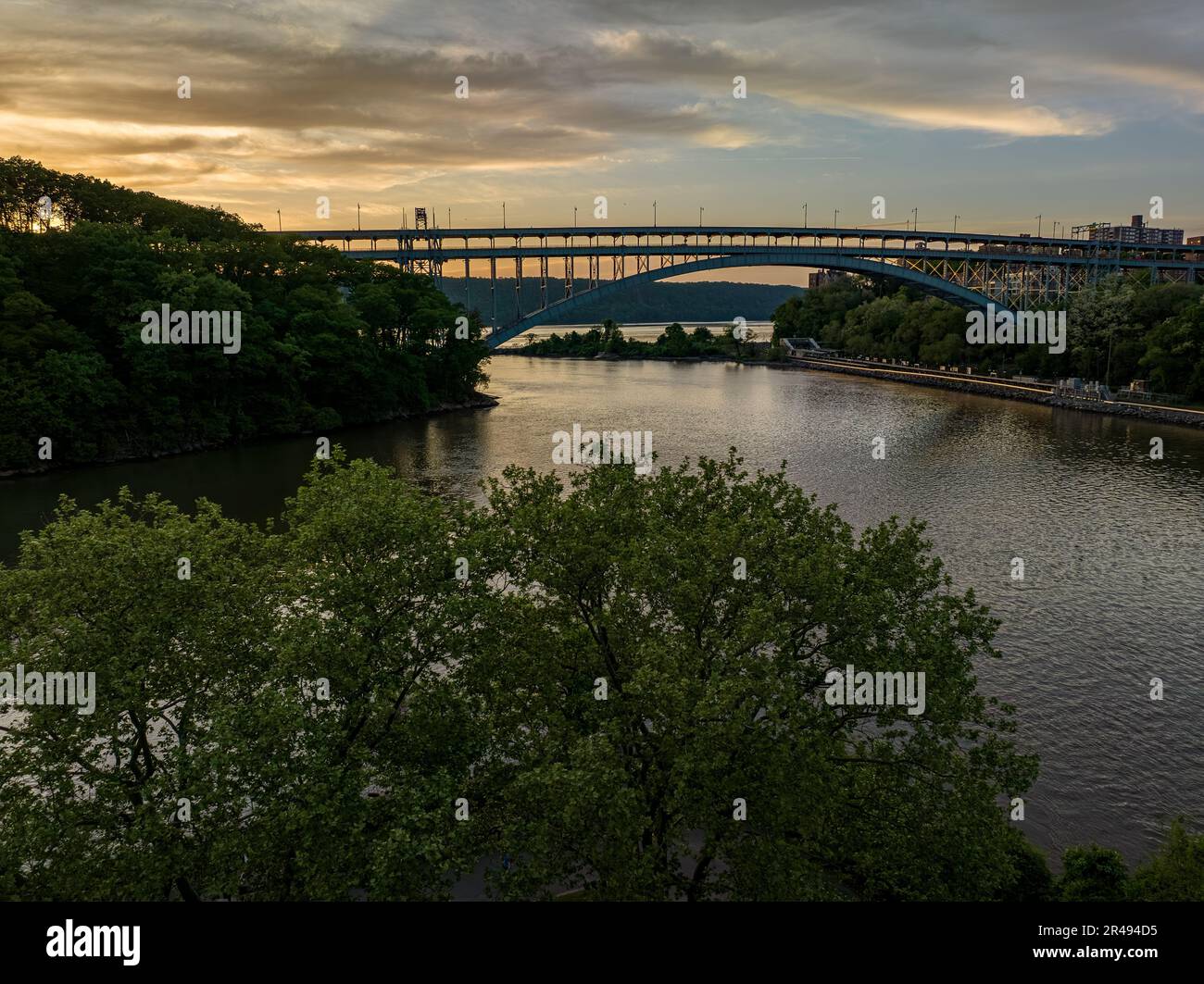 The Henry Hudson Bridge crossing the Spuyten Duyvil Creek at sunset in New York. Stock Photo
