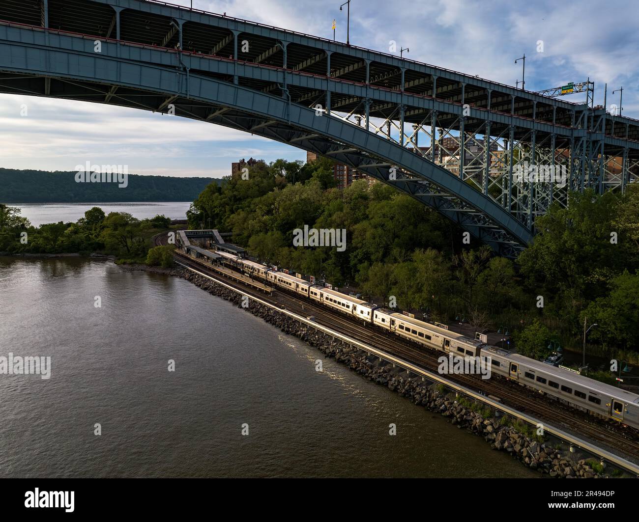 The Henry Hudson Bridge with a train passing under it. New York, USA. Stock Photo