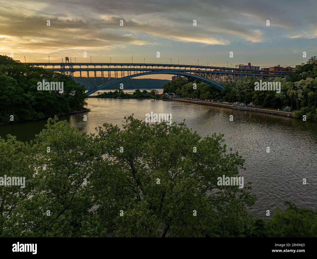 The Henry Hudson Bridge crossing the Spuyten Duyvil Creek at sunset in New York. Stock Photo