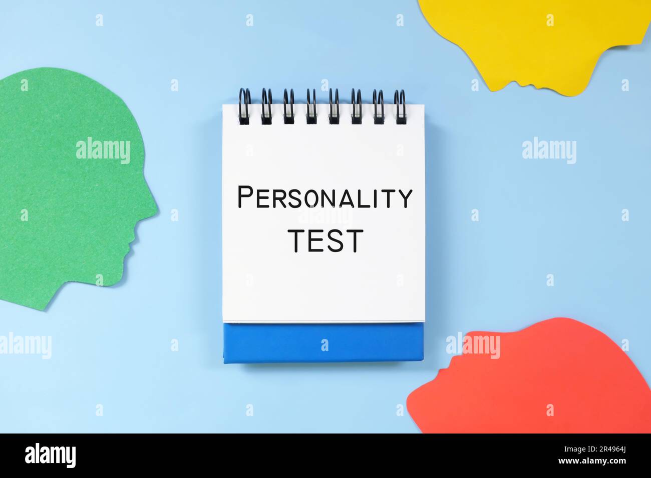 Personality test concept. Word written on blue notepad with human head profile silhouette. Stock Photo