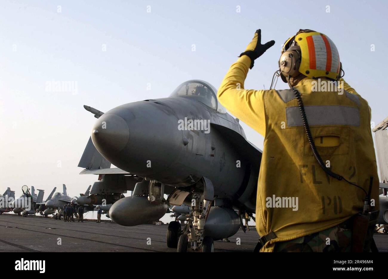 US Navy An Aircraft Director Maneuvers An F-A-18C Hornet Into A Holding ...