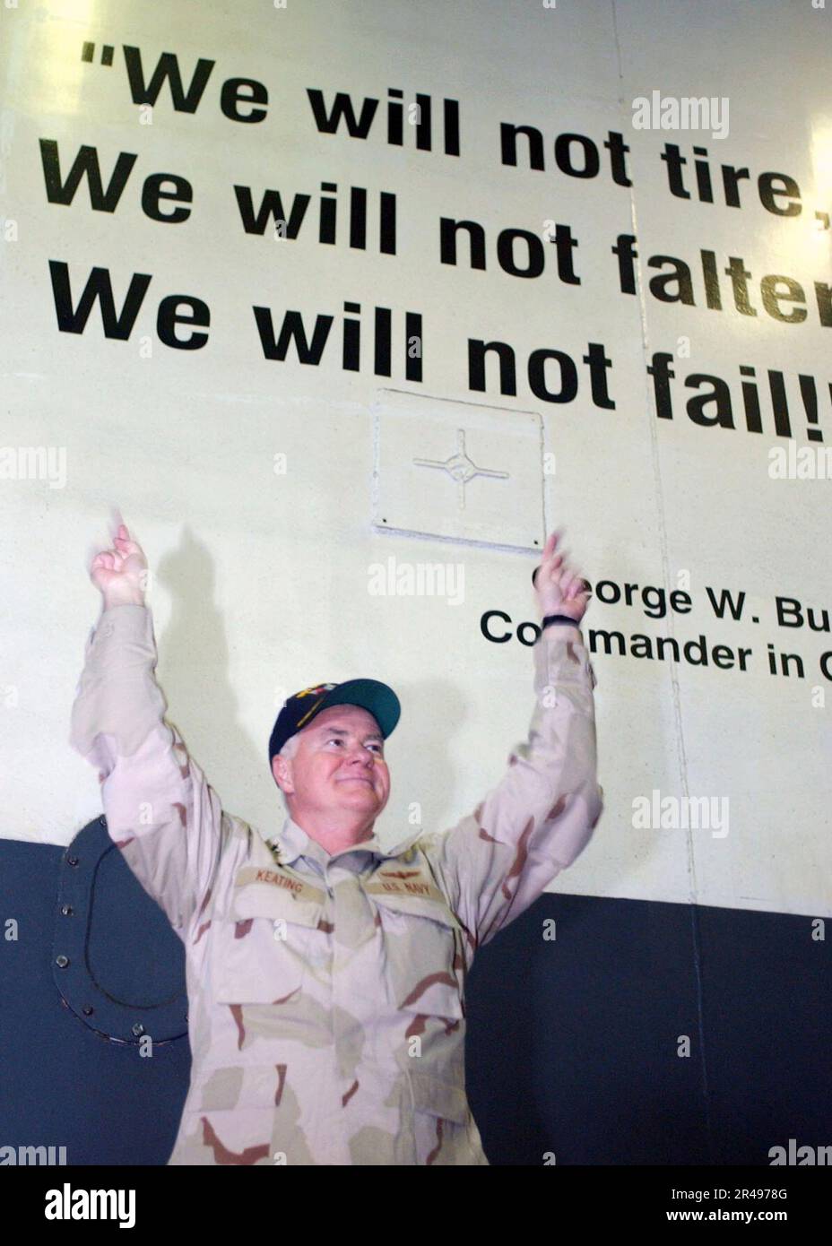 US Navy Vice Adm. Timothy J. Keating, Commander, Fifth Fleet uses a quote painted on the ship's hanger bay divisional doors We will not tire, we will not falter, we will not fail to represent the effor Stock Photo
