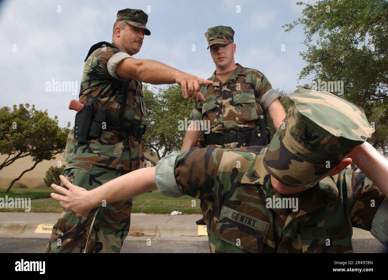US Navy MasteratArms 1st Class Timothy Fite instructs Hull Technician 2nd Class Brad Hurshey