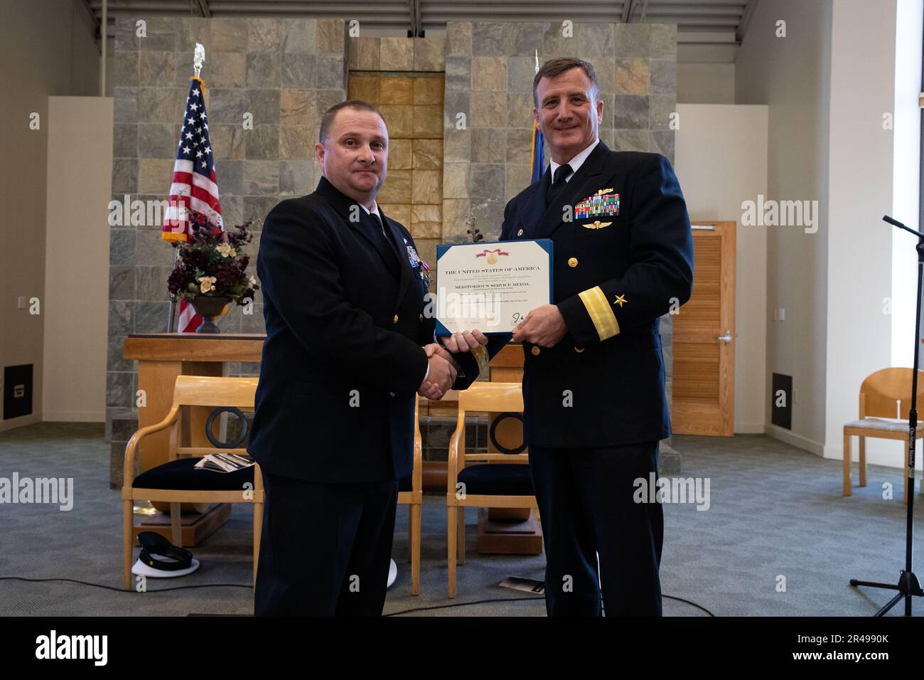 230331-N-XP477-1108 SAN DIEGO (March 31, 2023) – Rear Adm. Robert Chadwick II, right, presents Master Chief Operations Specialist Kermit L. Pollard with a Meritorious Service Medal during Pollard's retirement ceremony at the Murphy Canyon Chapel, March 31, 2023. Pollard is retiring after 27 years of dedicated service to the U.S. Navy. Stock Photo