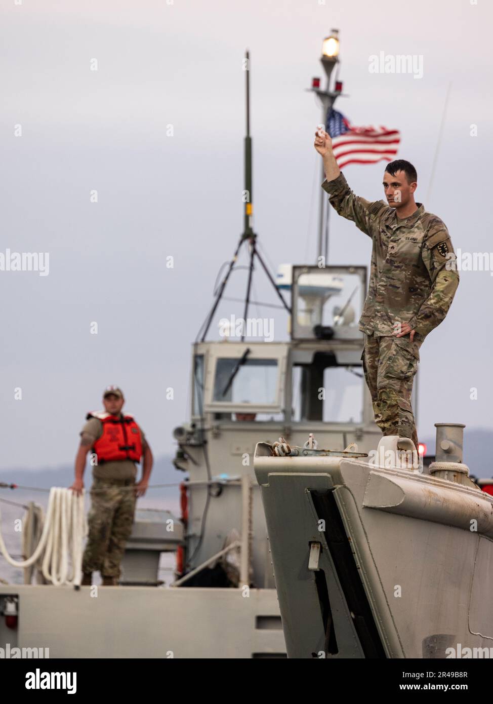 U.S. Army Soldiers signal from a Landing Craft Mechanized after ...