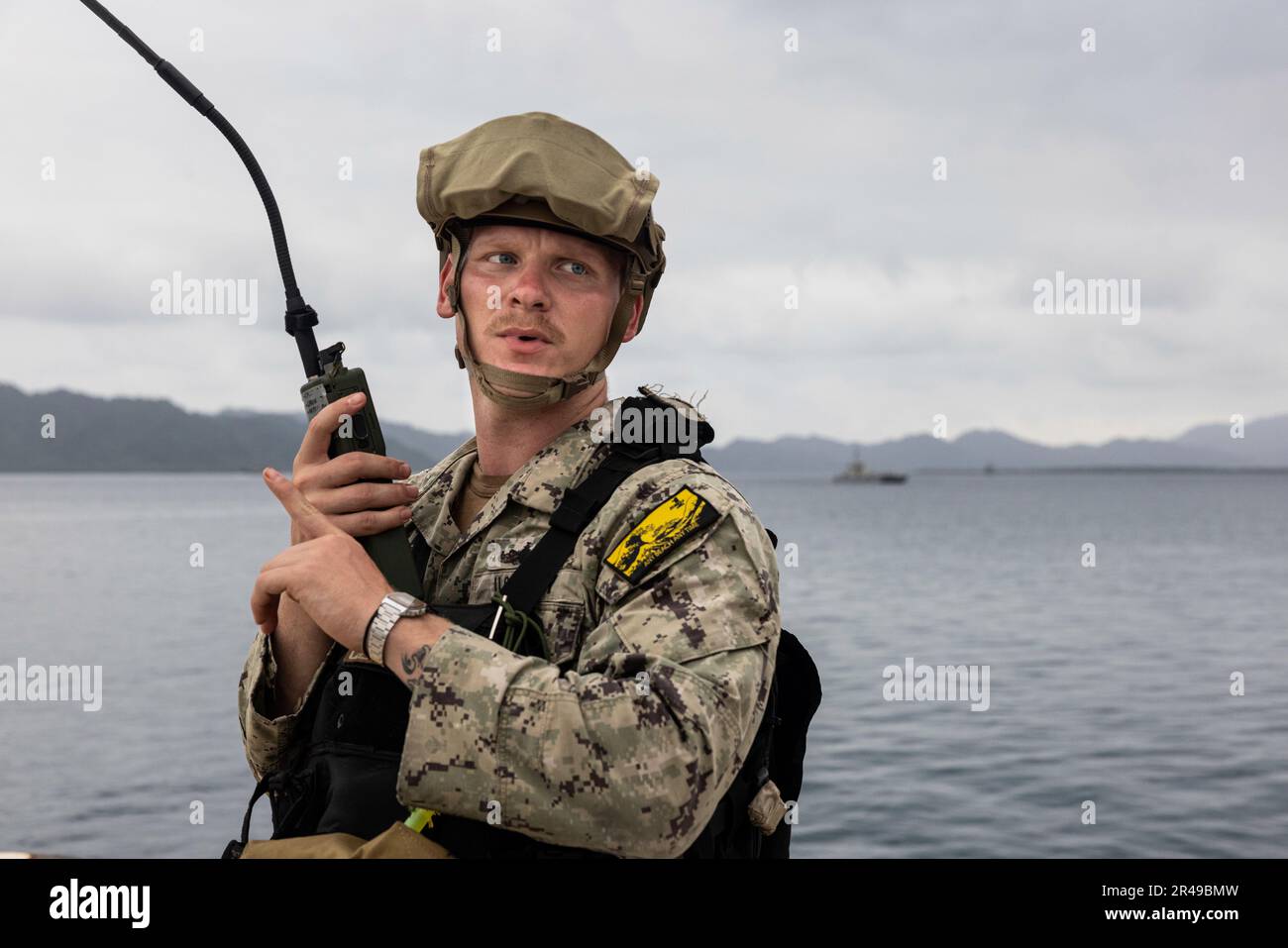 U.S. Navy Sailor Engineman 2nd Class Alec Sacco, with Beachmaster Unit 1, and a native of Plano, Texas, relays radio communications during a combined joint logistics over-the-shore offload in preparation for Balikatan 23 at Camp Agnew, Casiguran, Philippines, April 6, 2023. Balikatan is an annual exercise between the Armed Forces of the Philippines and U.S. military designed to strengthen bilateral interoperability, capabilities, trust, and cooperation built over decades shared experiences. Stock Photo