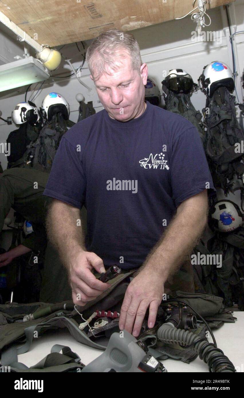 US Navy Aircrew Survival Equipmentman 1st Class inspects a survival