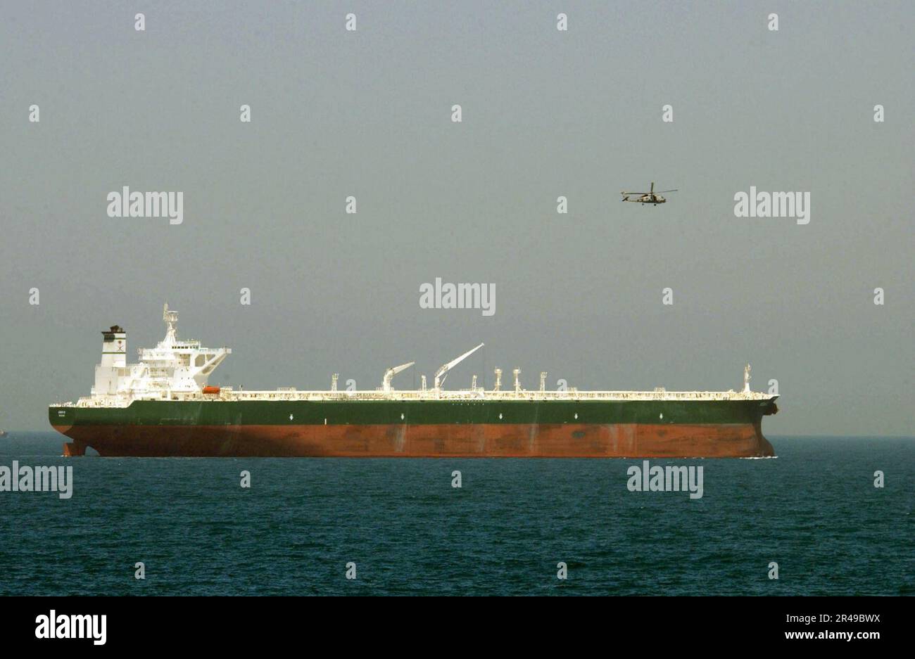 US Navy An SH-60 Seahawk attached to Light Helicopter Anti-Submarine Squadron Thirty Seven (HSL-37) provides aerial security for the commercial oil tanker AbQaiq Stock Photo