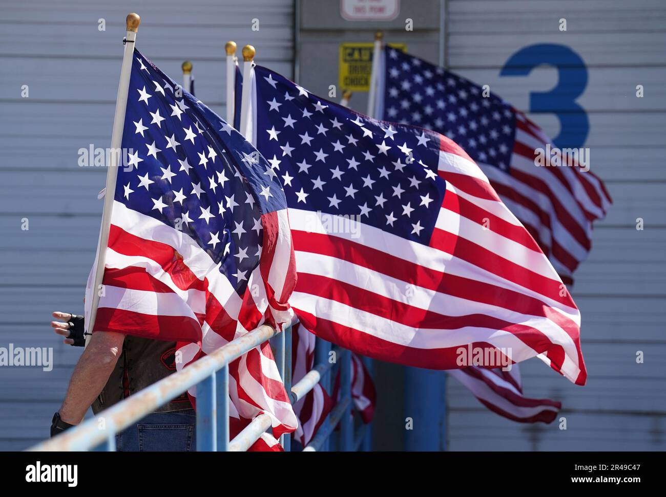 St. Louis, USA. 26th May, 2023. Members of the Patriot Guard hold onto their American flags in the wind, waiting for the casket containing the remains of World War II airman James M. Howie, to arrive at St. Louis-Lambert International Airport in St. Louis on Friday, May 26, 2023. Howie, who was killed in a crash in 1943 at the age of 24, was assigned to the 345th Bombardment Group aboard a B-24 Liberator bomber as a radio operator. Credit: UPI/Alamy Live News Stock Photo