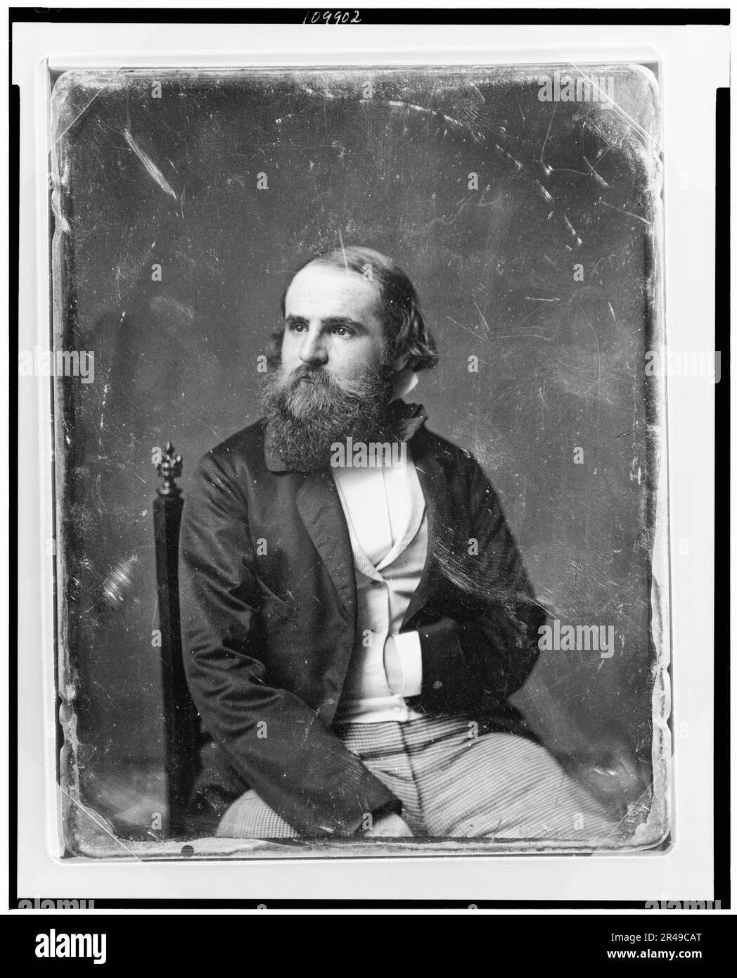 Unidentified man, about 40 years of age, three-quarter length portrait, slightly to the right, head three-quarters to the left, seated in chair, one hand in waistcoat, with full beard, between 1844 and 1860. Stock Photo