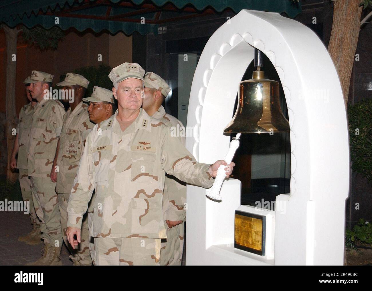 US Navy Vice Adm. Timothy J. Keating, Commander U.S. Naval Forces Central Command-Commander U.S. 5th Fleet, rings the base ship's bell as part of a July 4th ceremony at Naval Support Activity Bahrain Stock Photo