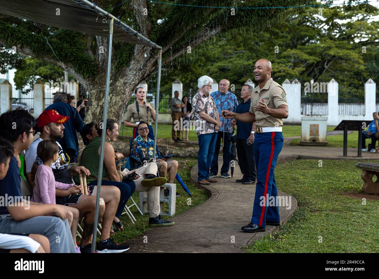 U.S. Marine Corps Staff Sgt. Uiliami Fihaki, an enlisted conductor with Marine Corps Forces Pacific Band, interacts with attendees during a live concert for the local community at Plaza de Espana, Hagatna, Guam, Jan. 23, 2023. The MARFORPAC Band participated in multiple community engagements during their visit to Guam as part of the Naval Support Activity, Marine Corps Base Camp Blaz Reactivation and Naming Ceremony. In order to encourage music education and showcase the vibrant history and tradition of military music, the band is active in providing clinics and concerts for the communities th Stock Photo