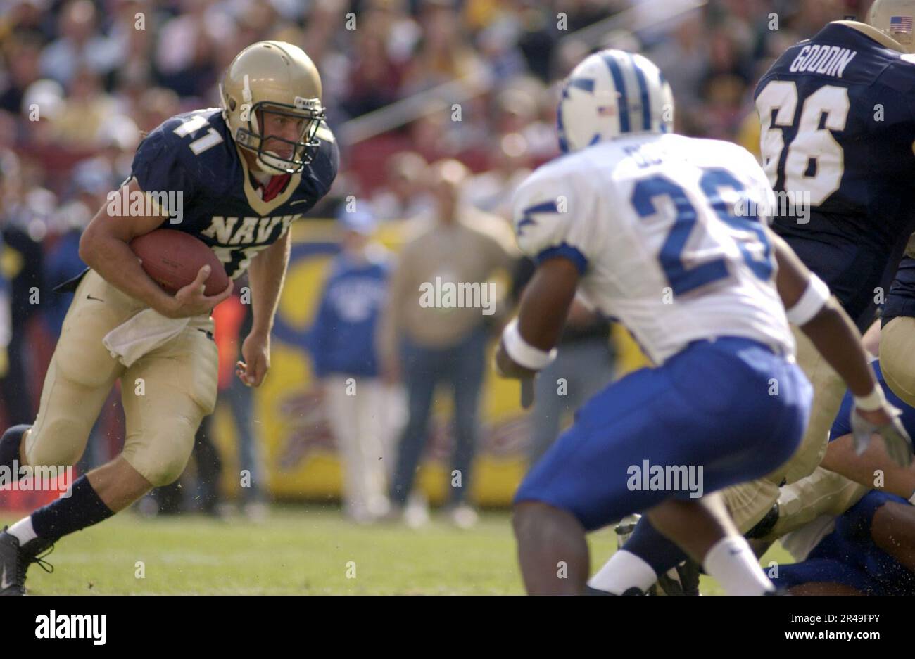 US Navy Navy quarterback Craig Candeto tries to out manuever Air Force defender Larry Duncan Stock Photo